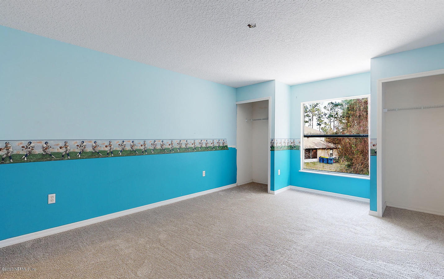 11939 Iron Creek Road Jacksonville, FL 32218 - Photo 22 of 45 an empty room with a fireplace and painted walls