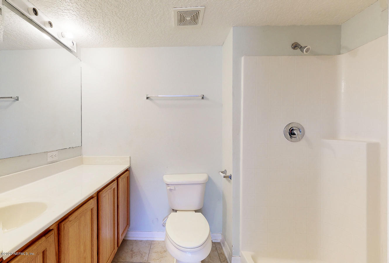 11939 Iron Creek Road Jacksonville, FL 32218 - Photo 27 of 45 a white toilet sitting next to a bathroom sink