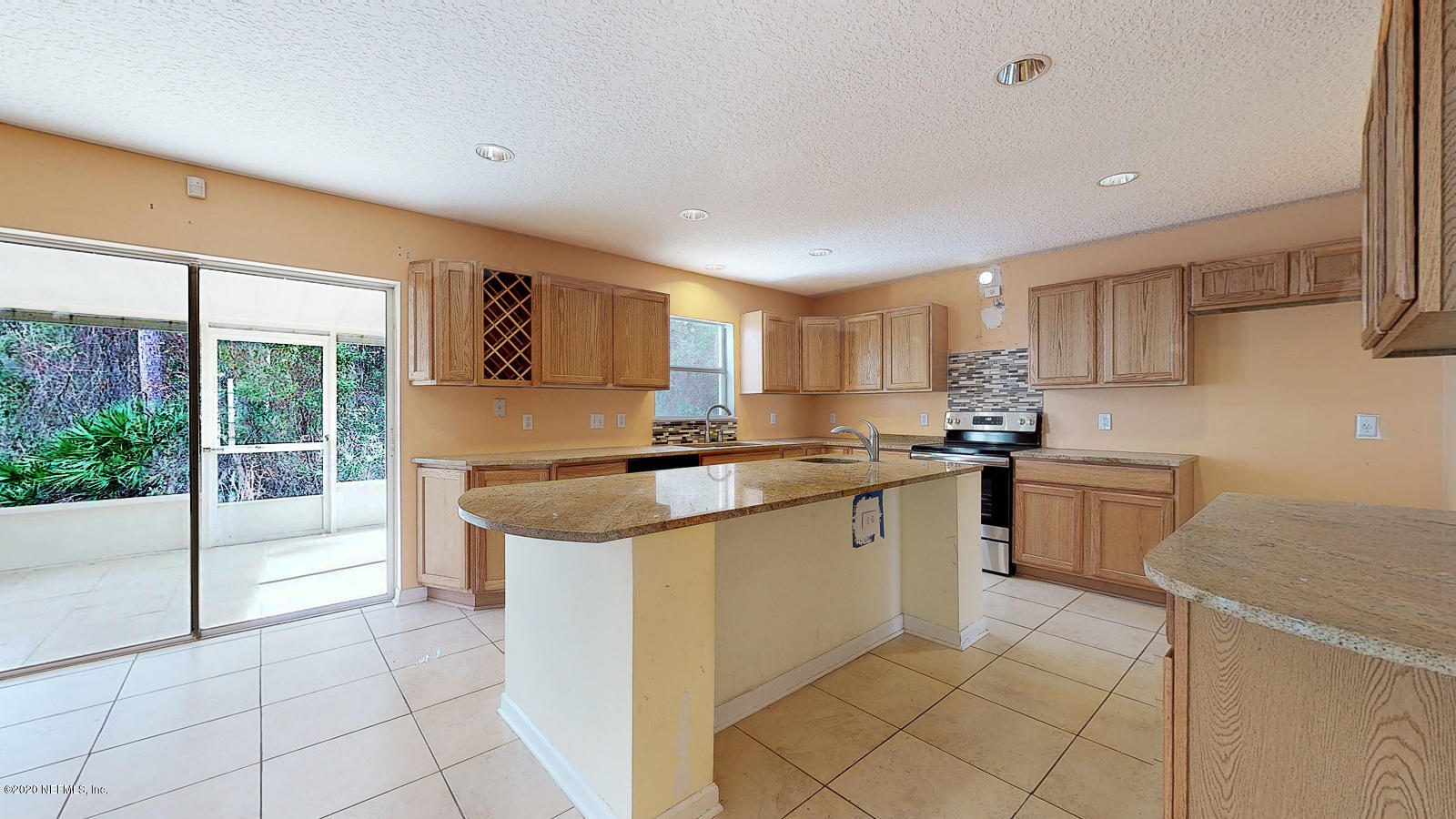 11939 Iron Creek Road Jacksonville, FL 32218 - Photo 5 of 45 a kitchen with stainless steel appliances granite countertop a stove a sink and a refrigerator