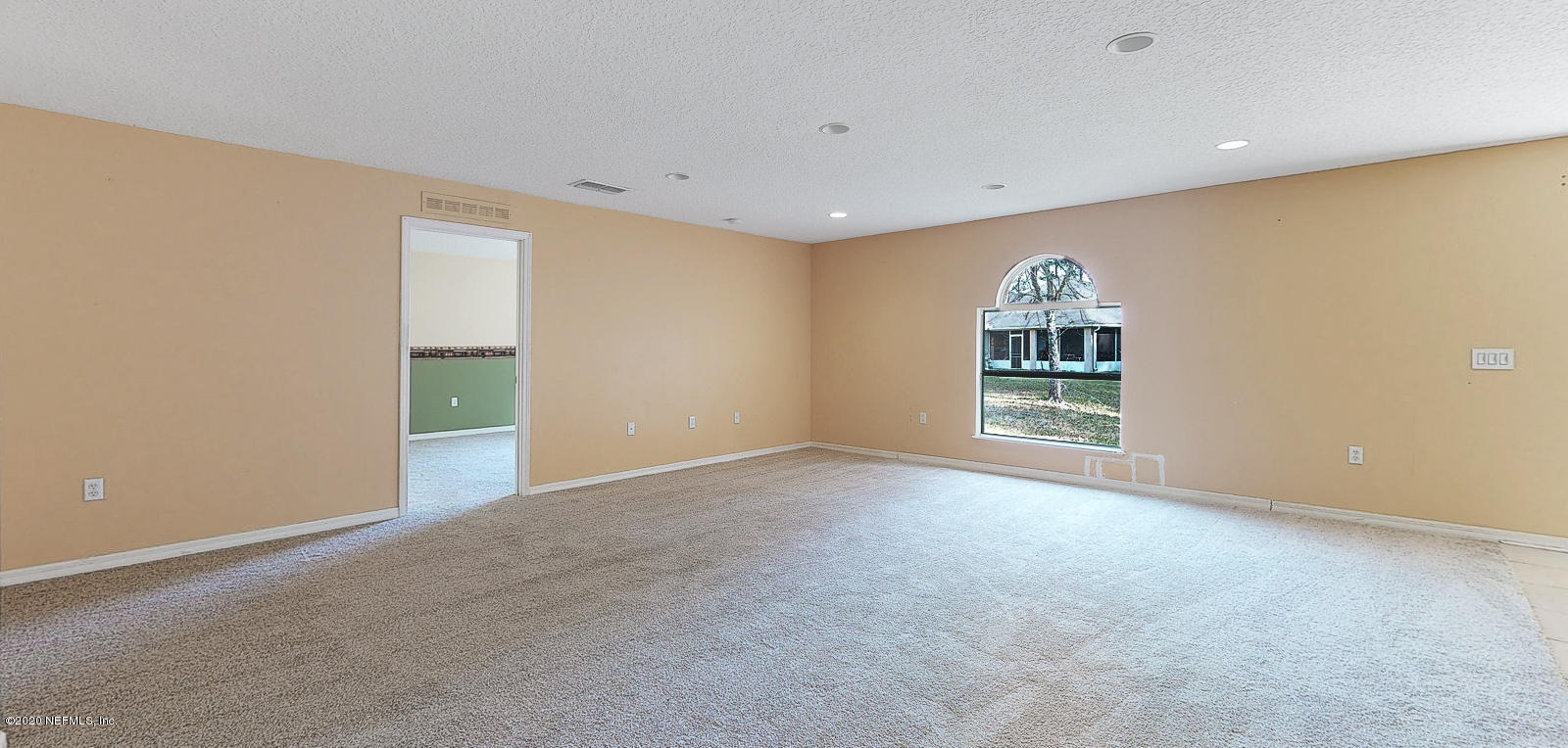 11939 Iron Creek Road Jacksonville, FL 32218 - Photo 10 of 45 a view of a big room with windows and chandelier fan