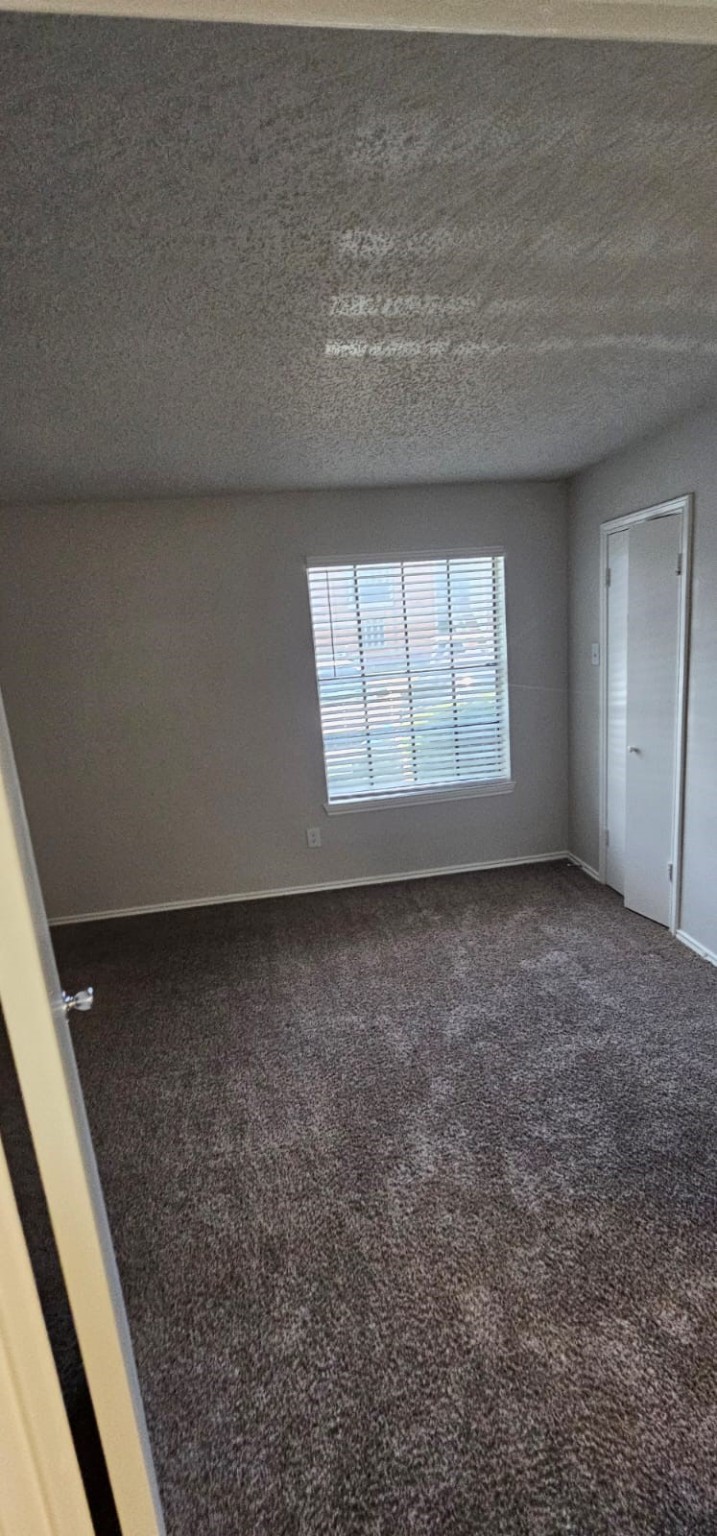 3737 Timberglen Road, Unit 2712 Dallas, TX 75287 - Photo 6 of 19 a view of an empty room and a window