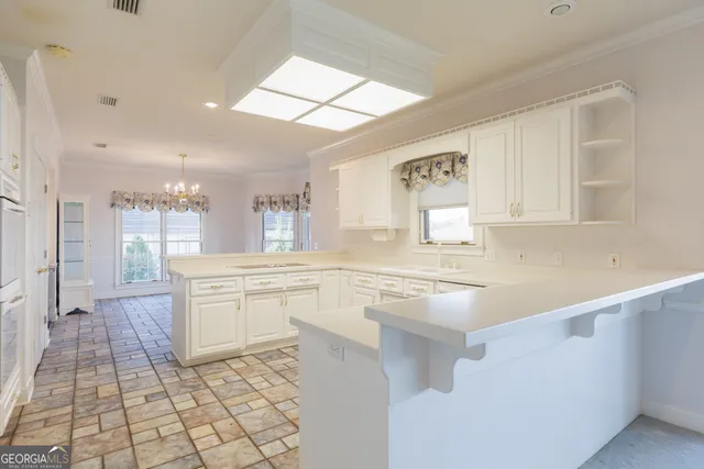 a kitchen with a sink cabinets and window