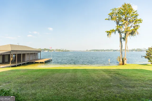 a view of a house with swimming pool and ocean view