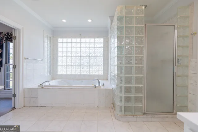 a bathroom with a bathtub a shower and a sink