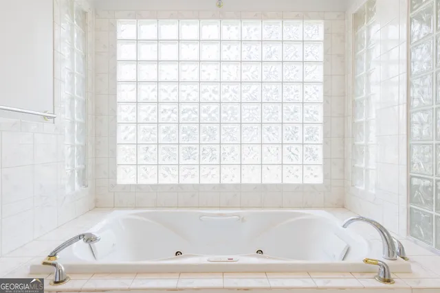 a white bath tub sitting next to a window