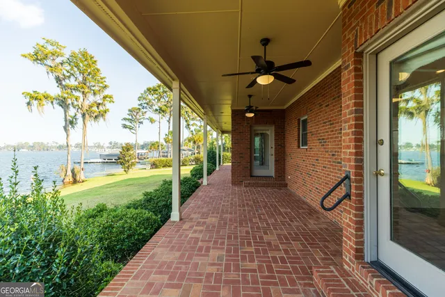 a view of a porch with a floor to ceiling window and wooden floor