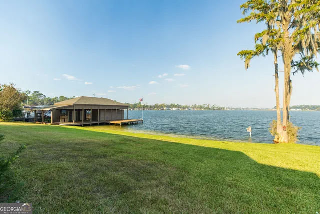 a view of a house with swimming pool and a yard