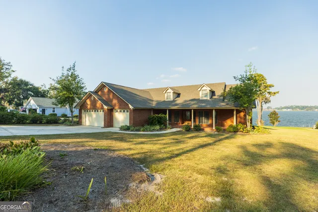 a front view of a house with a yard table and chairs