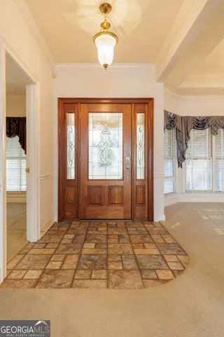 a view of a bedroom with wooden floor and windows
