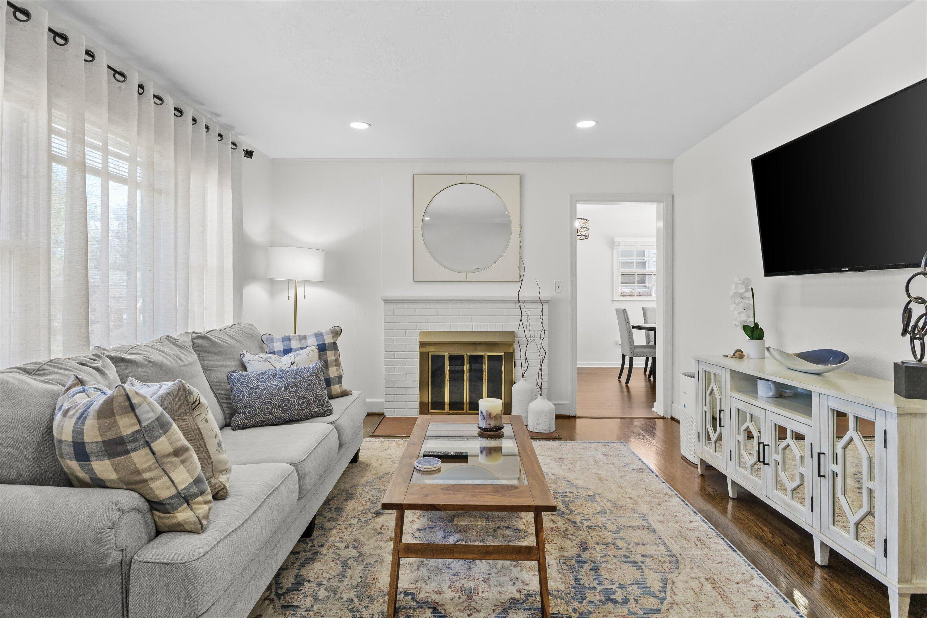 2650 Laburnum Avenue Southwest Roanoke, VA 24015 - Photo 4 of 37 a living room with furniture a flat screen tv and a fireplace