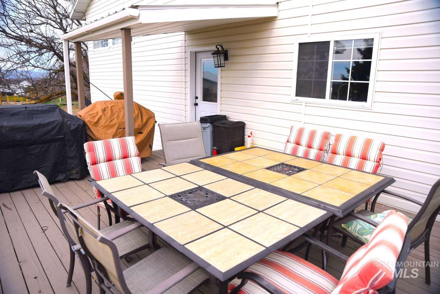 1065 Loafer Lane Weiser, ID 83672 - Photo 12 of 36 Deck with outdoor dining space and area for grilling