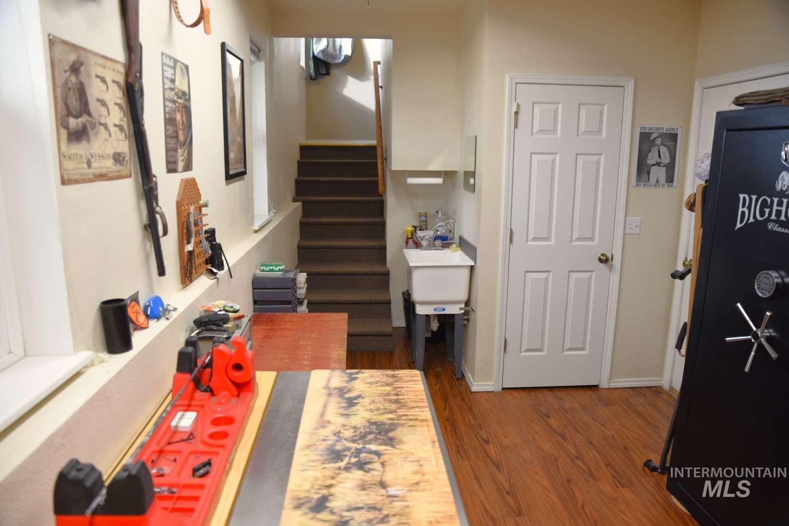 1065 Loafer Lane Weiser, ID 83672 - Photo 19 of 36 Corridor featuring dark wood-type flooring and stairs