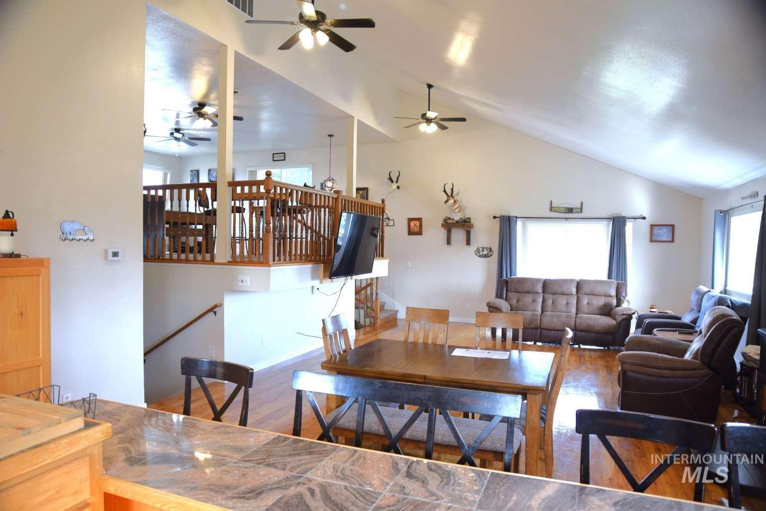 1065 Loafer Lane Weiser, ID 83672 - Photo 26 of 36 Dining room featuring wood finished floors, lofted ceiling, and ceiling fan
