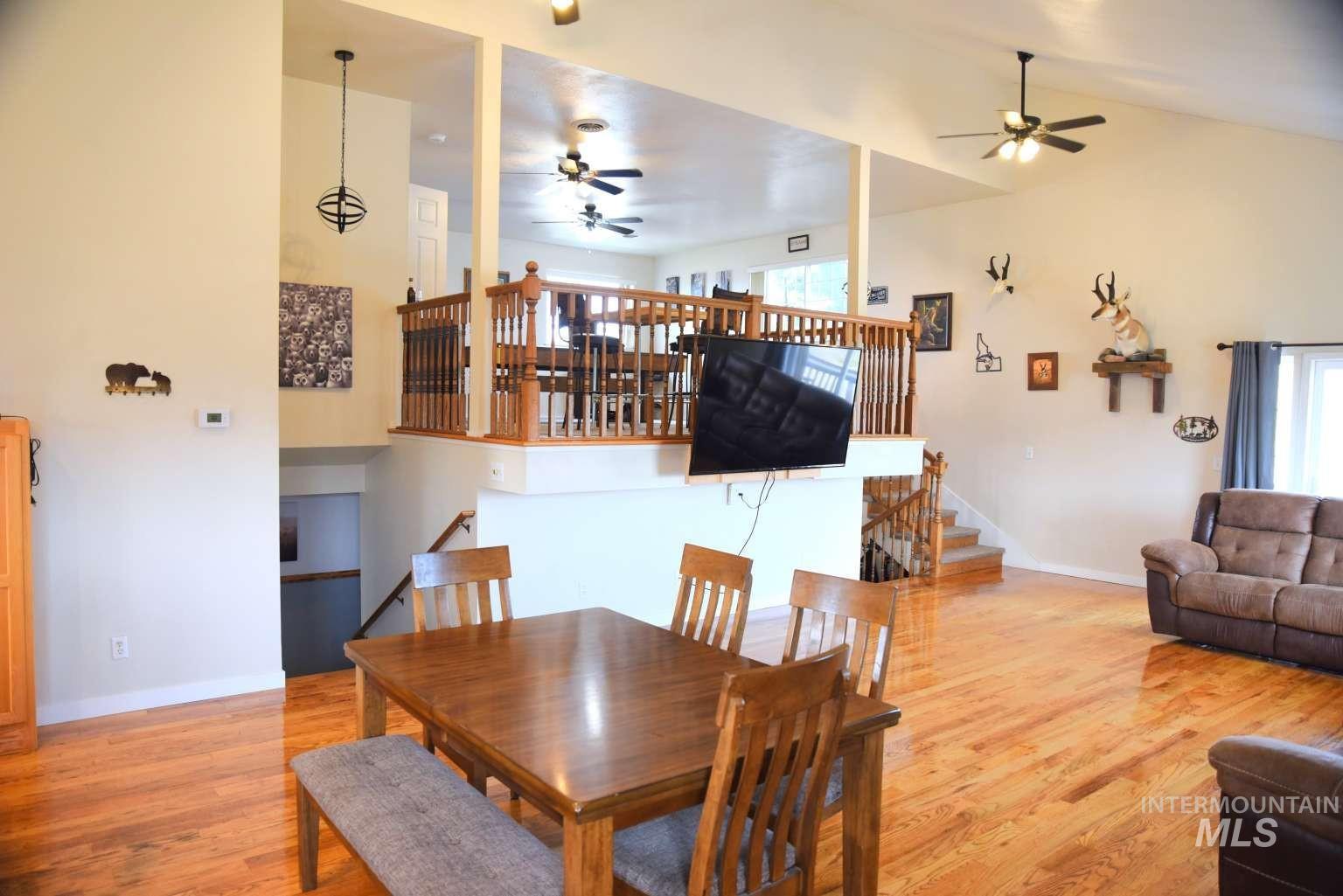 1065 Loafer Lane Weiser, ID 83672 - Photo 27 of 36 Dining area featuring light wood-style floors, a ceiling fan, and lofted ceiling