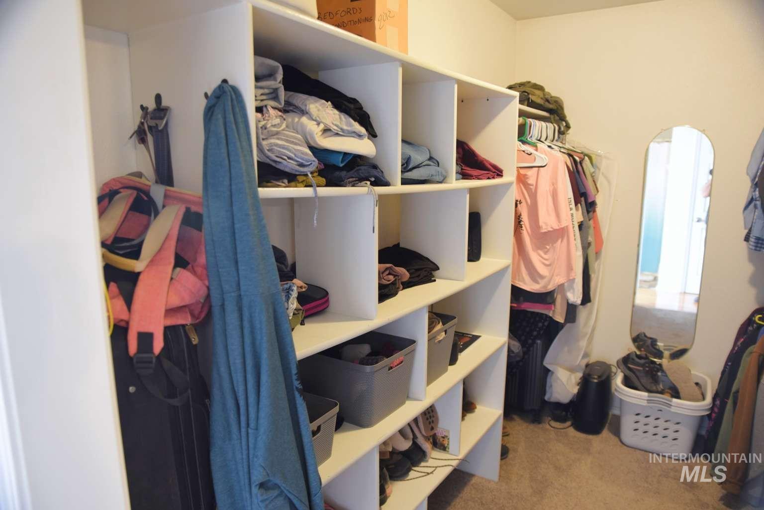 1065 Loafer Lane Weiser, ID 83672 - Photo 32 of 36 Walk in closet with light colored carpet and arched walkways