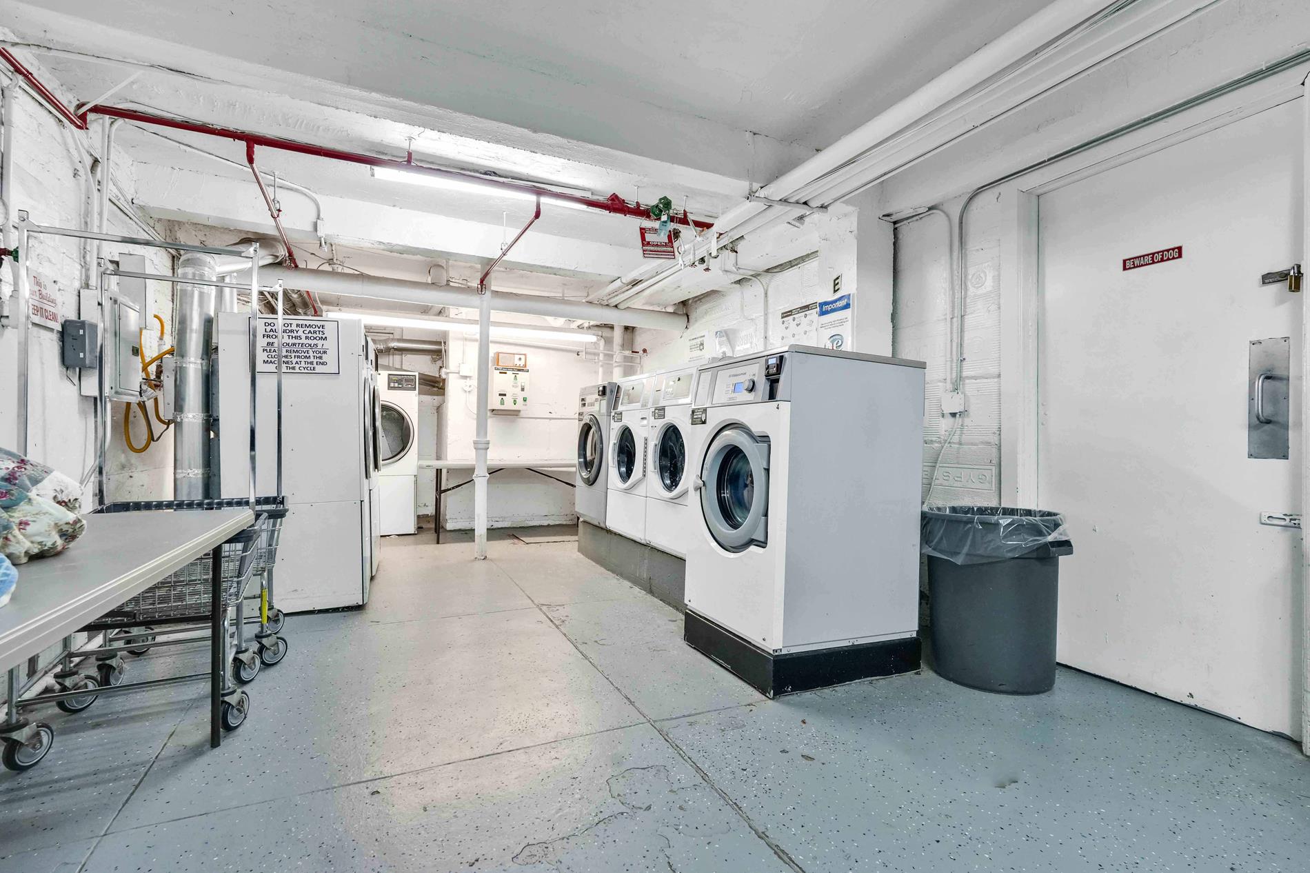 34-20 83rd Street, Unit 4F Queens, NY 11372 - Photo 11 of 12 a utility room with refrigerator and washer