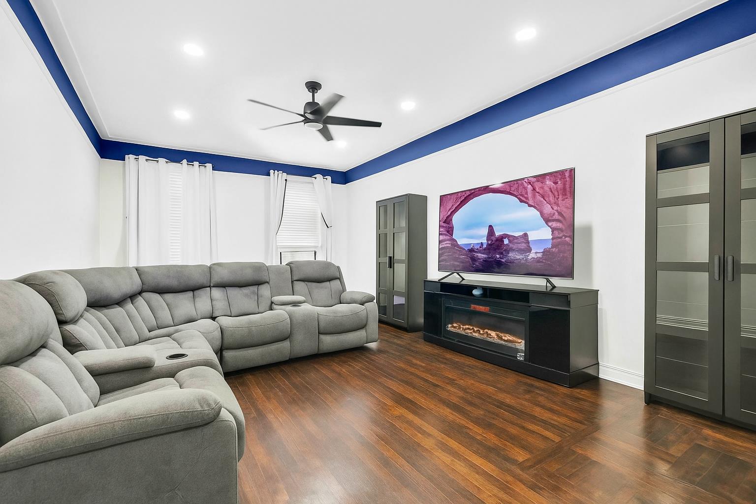 34-20 83rd Street, Unit 4F Queens, NY 11372 - Photo 3 of 12 a living room with furniture a flat screen tv and a ceiling fan