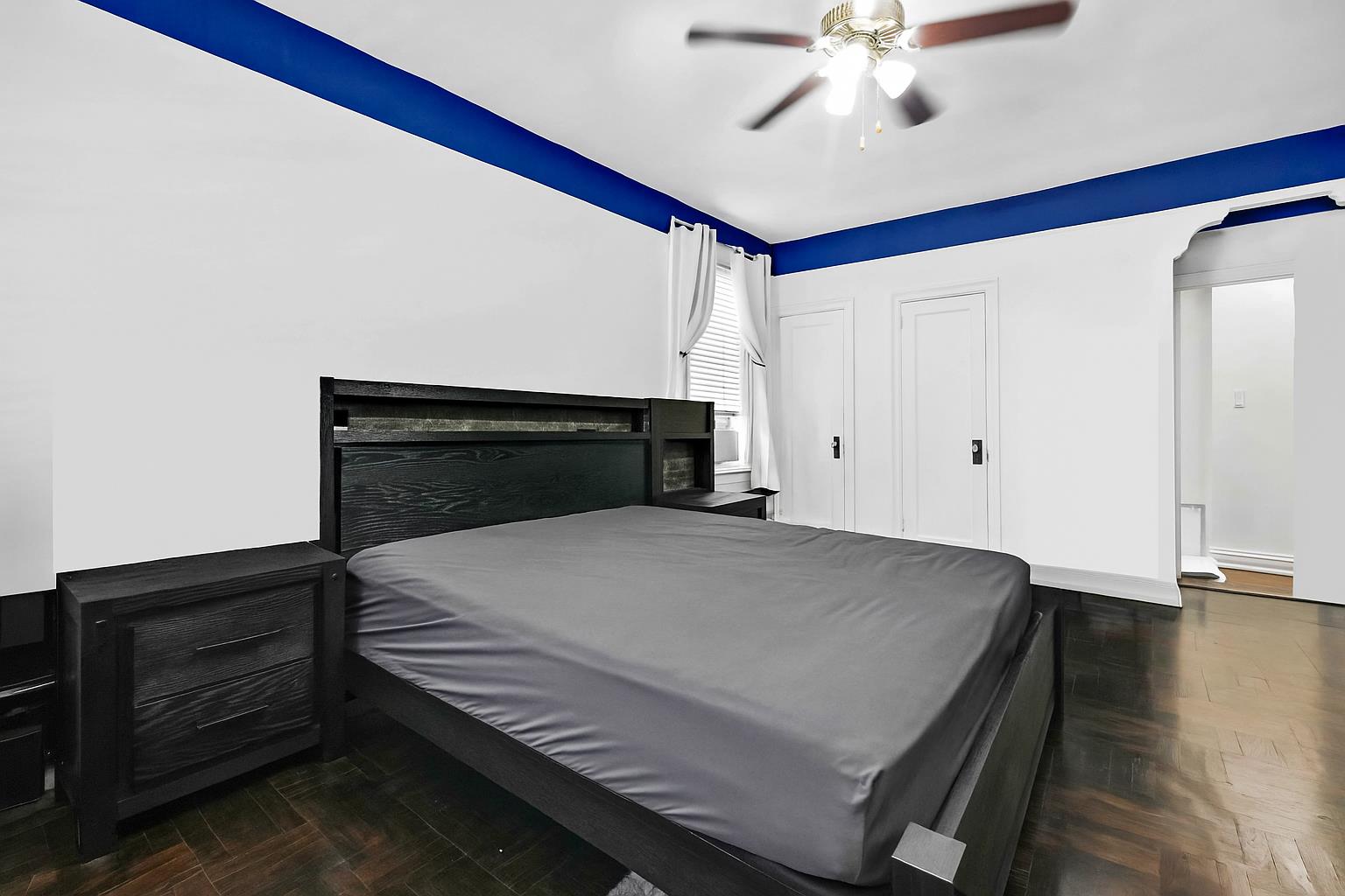 34-20 83rd Street, Unit 4F Queens, NY 11372 - Photo 6 of 12 a bedroom with a bed and a ceiling fan