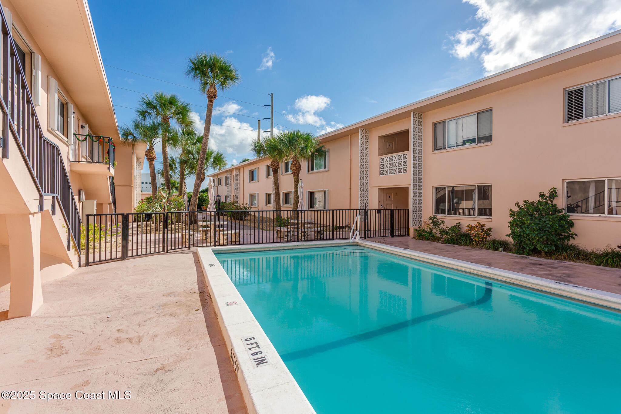 1700 Atlantic Street, Unit 9 Melbourne Beach, FL 32951 - Photo 15 of 30 a swimming pool with outdoor seating and yard