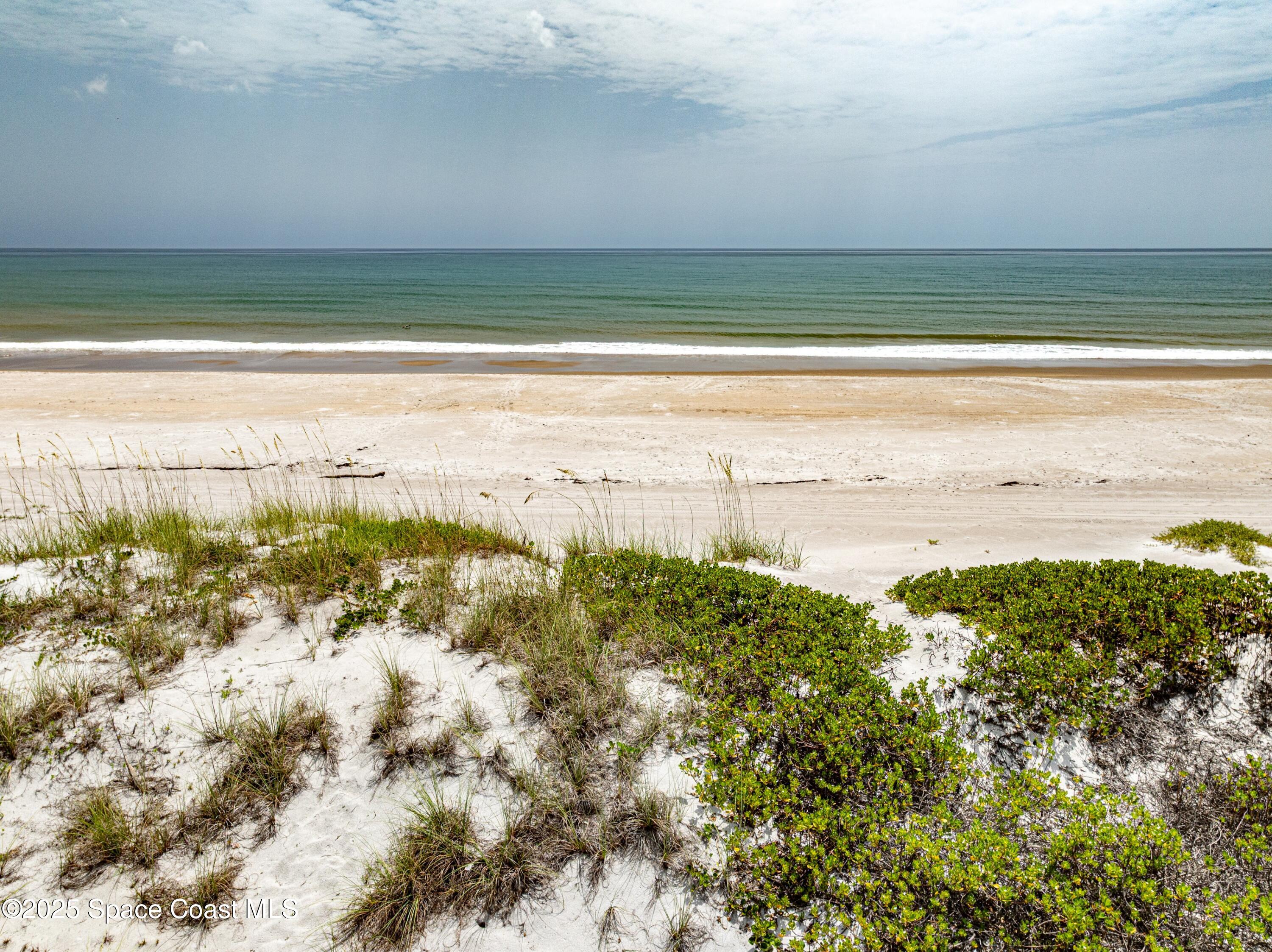 1700 Atlantic Street, Unit 9 Melbourne Beach, FL 32951 - Photo 20 of 30 a view of an ocean and beach