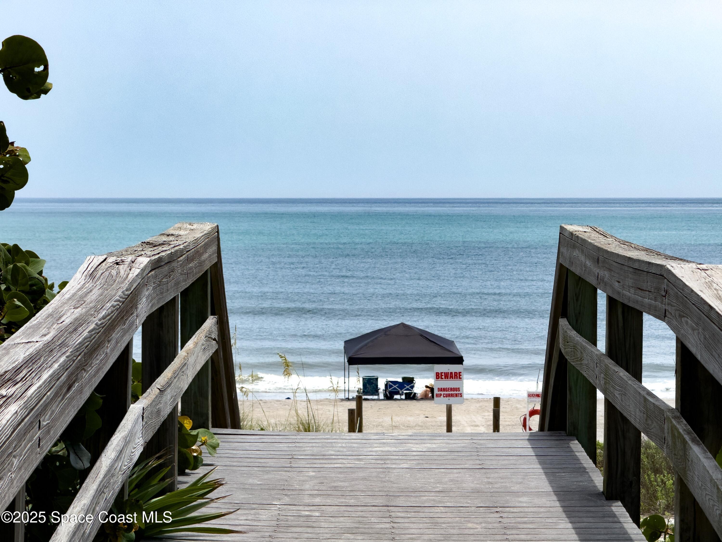 1700 Atlantic Street, Unit 9 Melbourne Beach, FL 32951 - Photo 26 of 30 a balcony with table and chairs