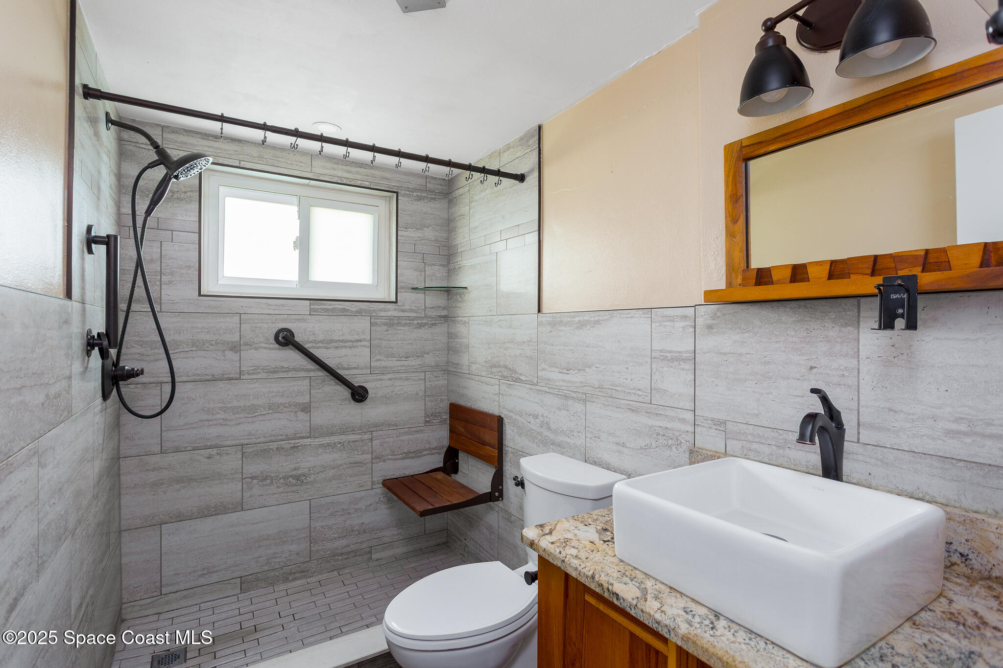 1700 Atlantic Street, Unit 9 Melbourne Beach, FL 32951 - Photo 9 of 30 a bathroom with a sink a toilet and shower