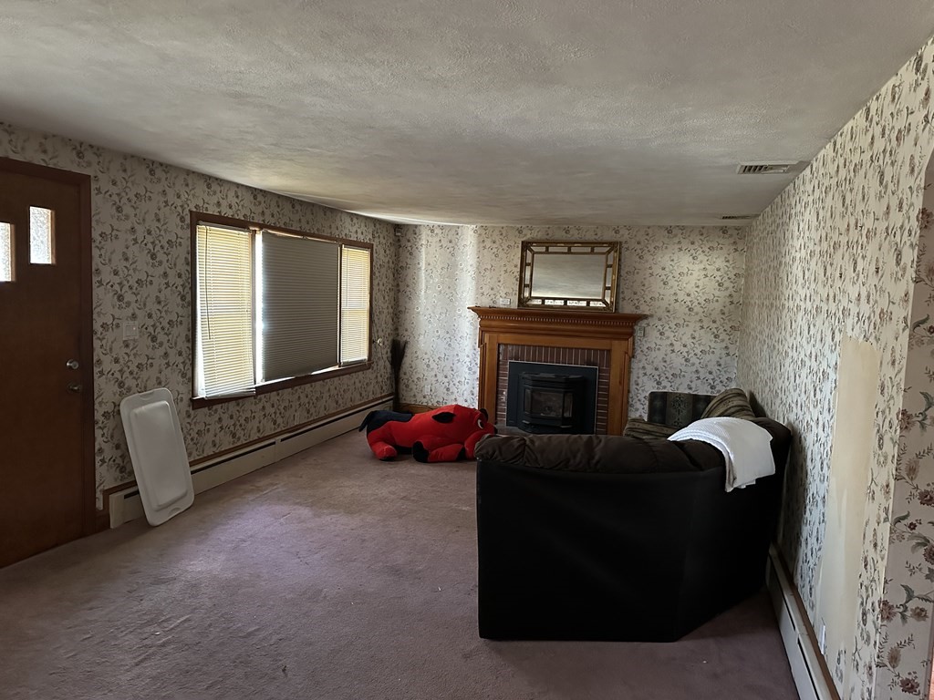 212 Almira Road Springfield, MA 01119 - Photo 3 of 3 a living room with furniture and a fireplace
