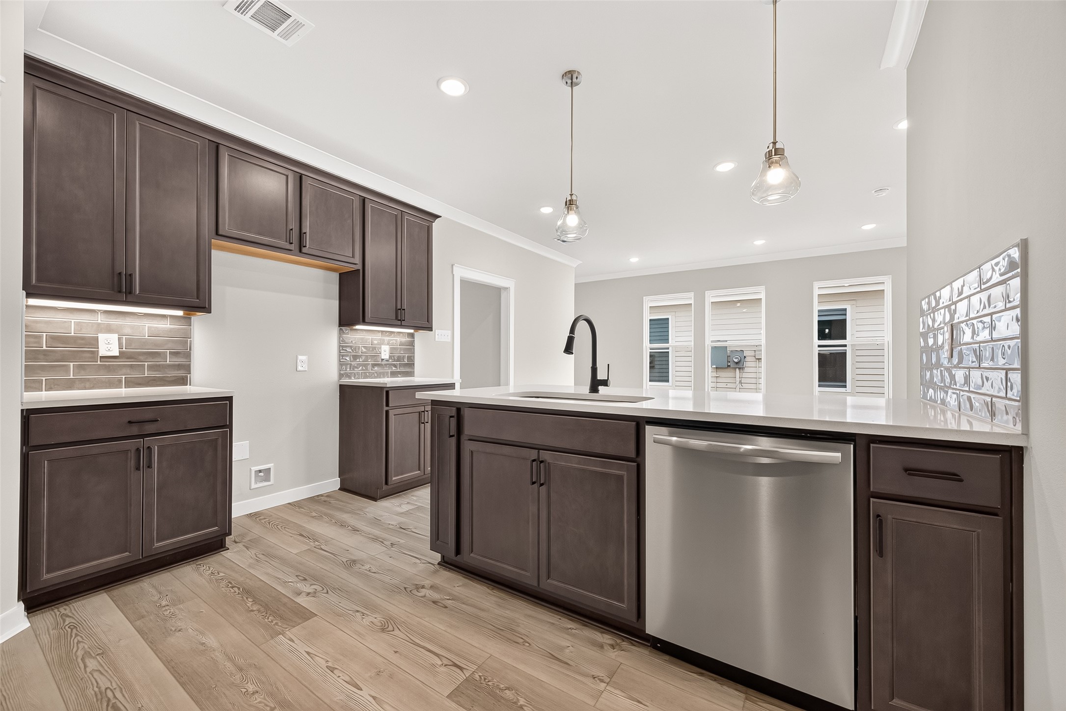 21122 Autumn Heights Rosharon, TX 77583 - Photo 16 of 42 a open kitchen with stainless steel appliances granite countertop a refrigerator a sink dishwasher a stove and white countertops with wooden floor