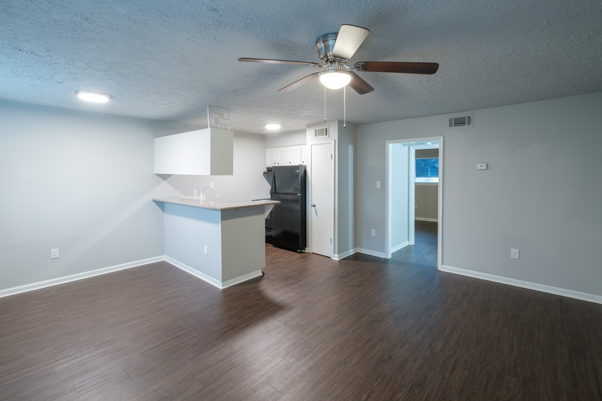 6519 Sloan Street, Unit 4 Houston, TX 77087 - Photo 5 of 11 wooden floor in an empty room with a kitchen