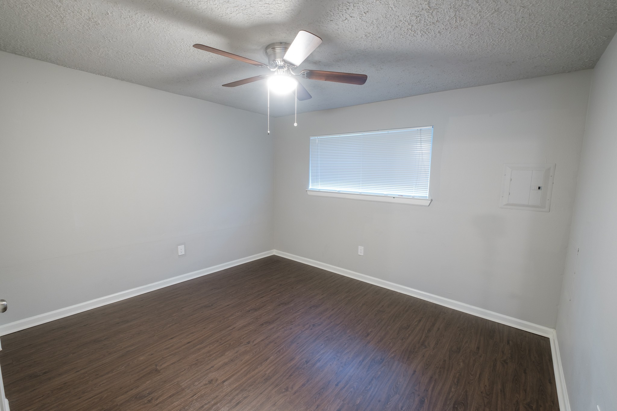 6519 Sloan Street, Unit 4 Houston, TX 77087 - Photo 7 of 11 an empty room with wooden floor and windows