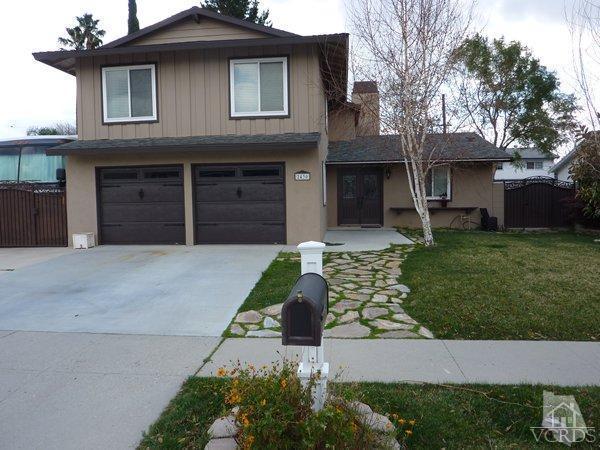 2430 Invar Court Simi Valley, CA 93065 - Photo 1 of 26 a front view of a house with a yard and garage