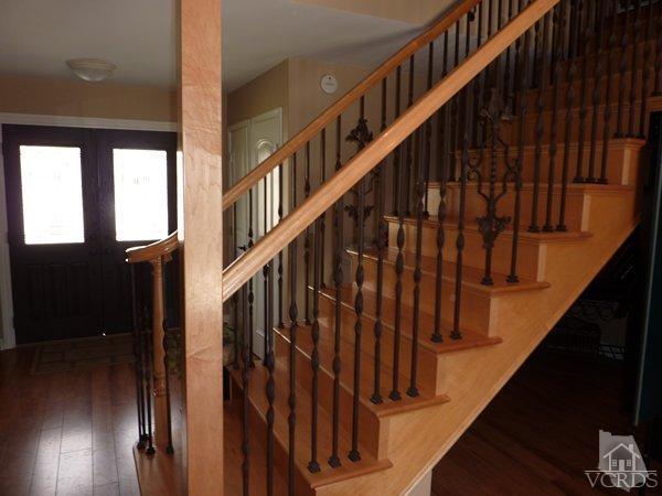 2430 Invar Court Simi Valley, CA 93065 - Photo 13 of 26 a view of staircase with wooden floor and white walls