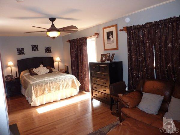2430 Invar Court Simi Valley, CA 93065 - Photo 15 of 26 a bedroom with a bed and wooden floor