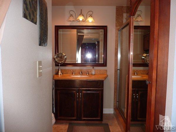 2430 Invar Court Simi Valley, CA 93065 - Photo 17 of 26 a bathroom with a sink and a mirror