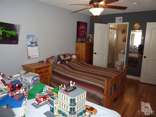 2430 Invar Court Simi Valley, CA 93065 - Photo 19 of 26 a bedroom with a bed and wooden floor
