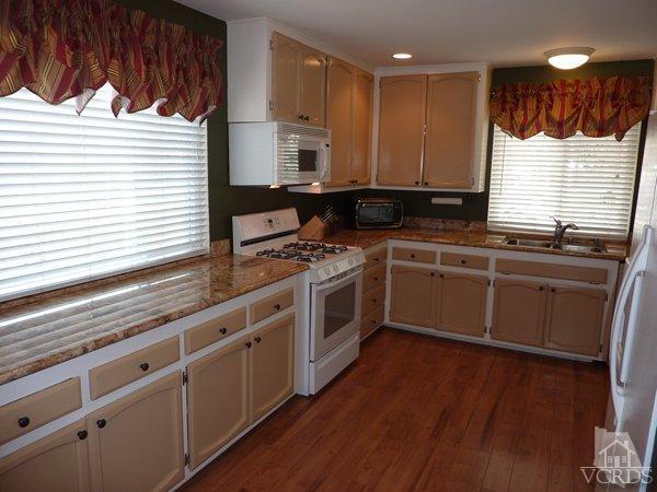2430 Invar Court Simi Valley, CA 93065 - Photo 5 of 26 a kitchen with stainless steel appliances kitchen island granite countertop a stove a sink and a microwave