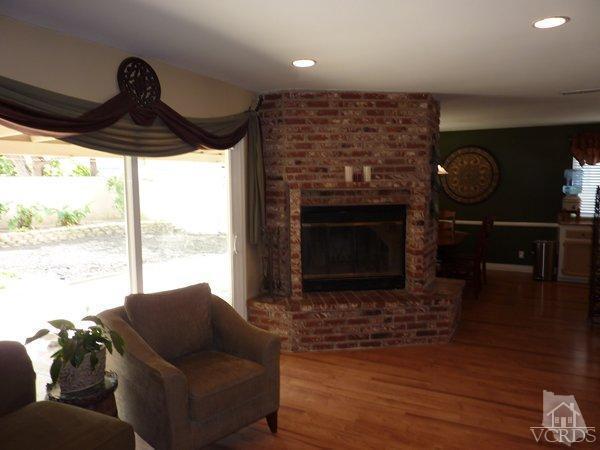 2430 Invar Court Simi Valley, CA 93065 - Photo 7 of 26 a living room with furniture a window and a fireplace