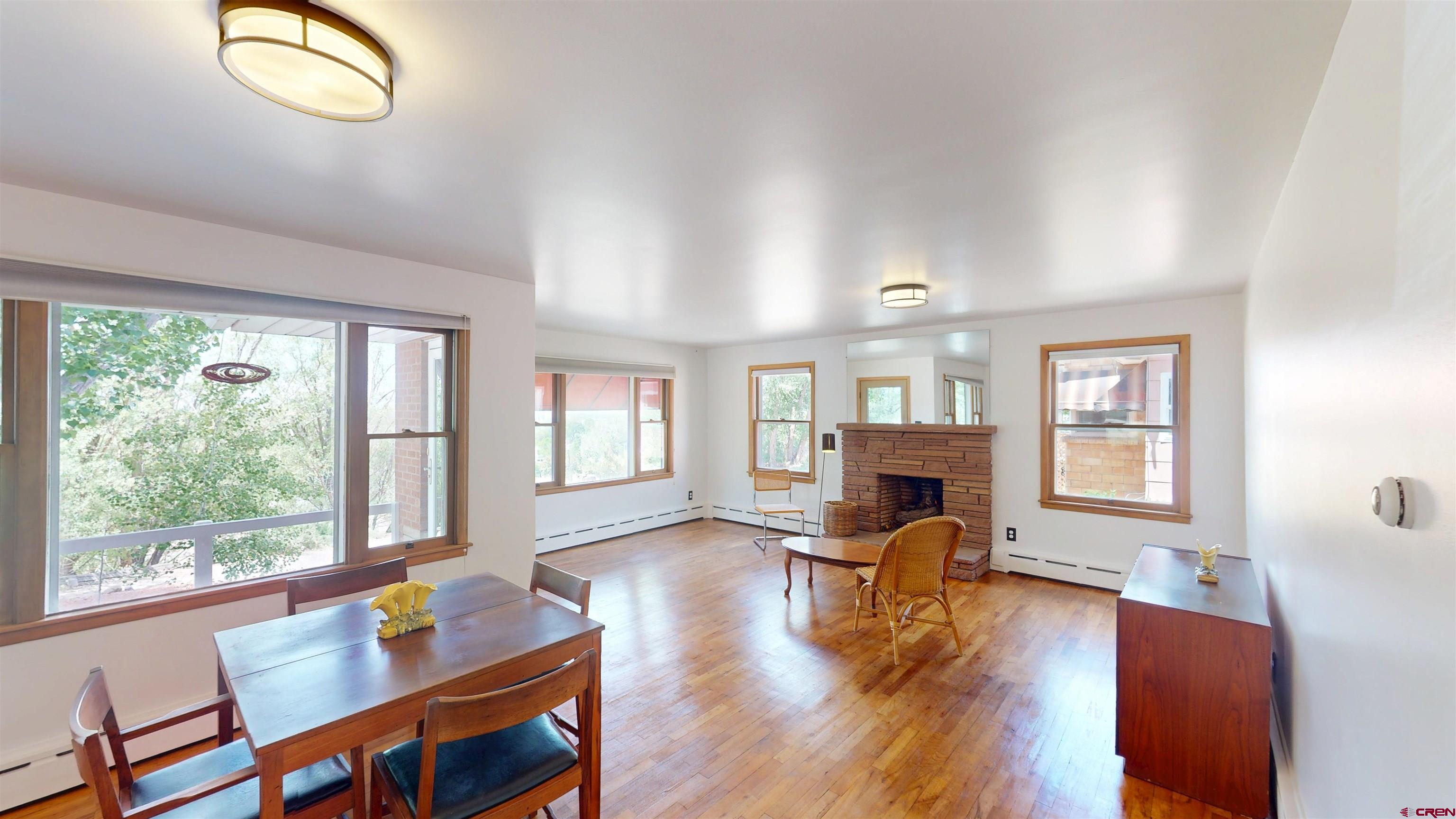 a living room with fireplace furniture and a wooden floor