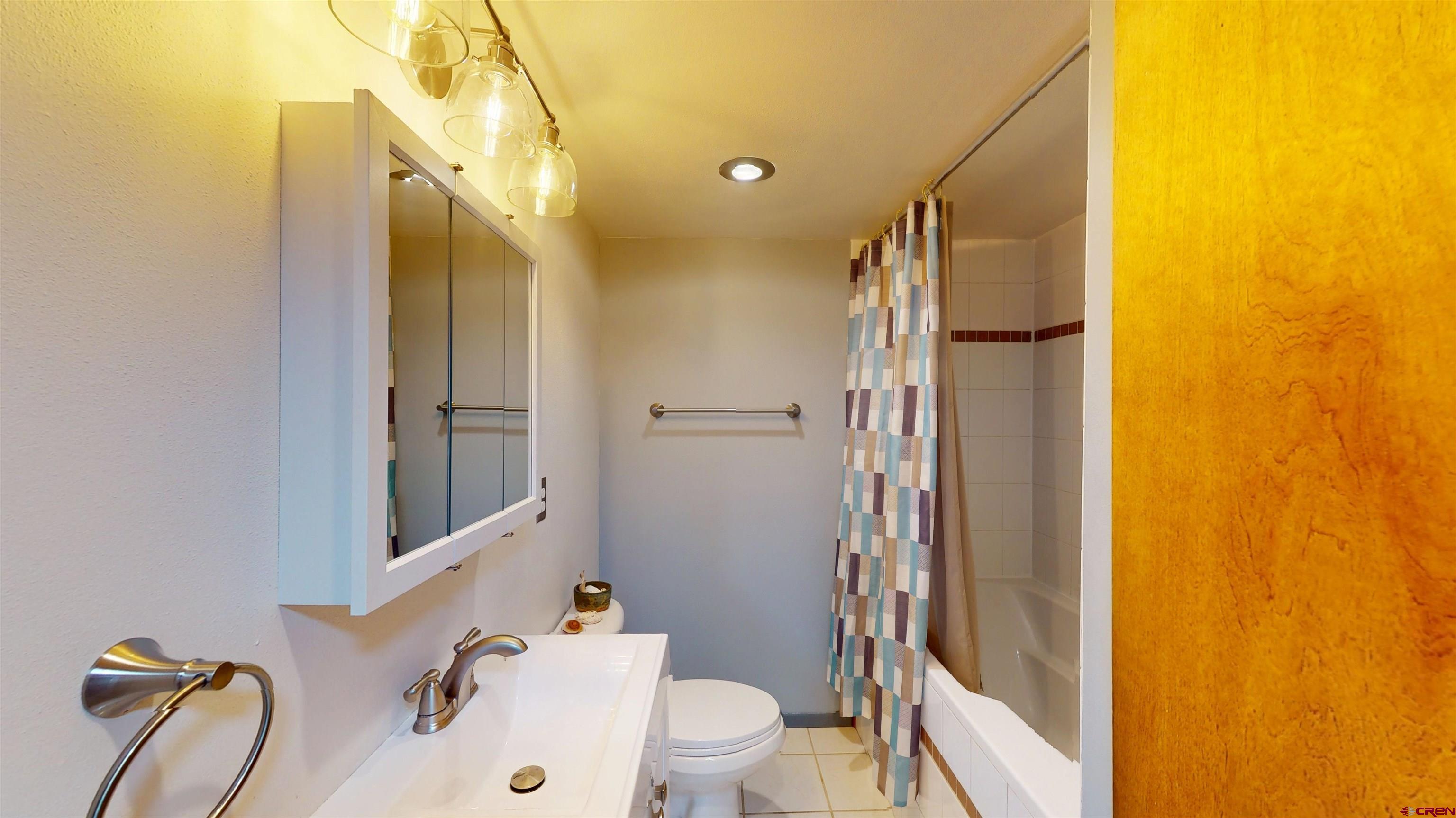 320 Grand Boulevard Delta, CO 81416 - Photo 21 of 38 a bathroom with a sink mirror vanity and toilet