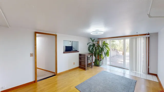 a view of a livingroom with furniture and floor to ceiling window
