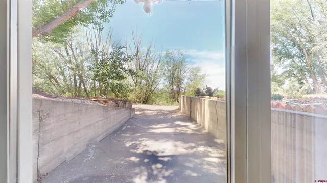 a view of a back yard from a corridor