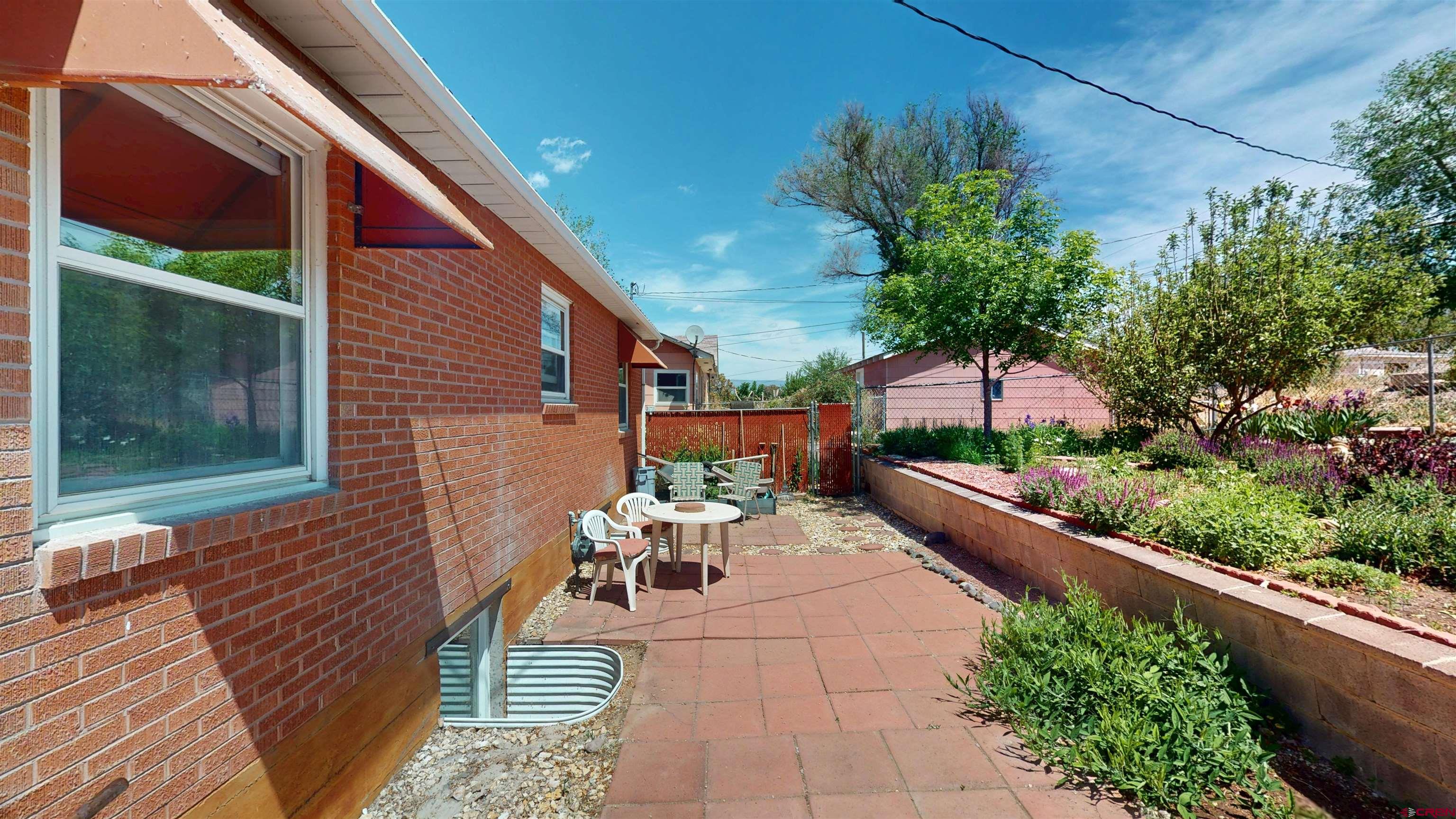 320 Grand Boulevard Delta, CO 81416 - Photo 32 of 38 a view of a patio with couches table and chairs and potted plants