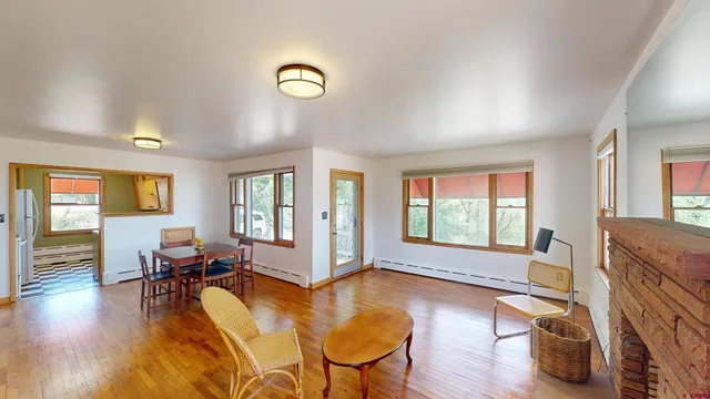 a living room with fireplace furniture and a wooden floor