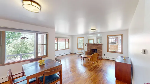 a living room with furniture fireplace and window