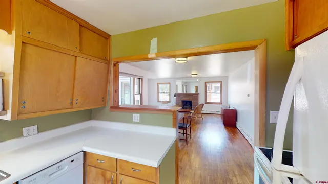 a kitchen with furniture and a large window