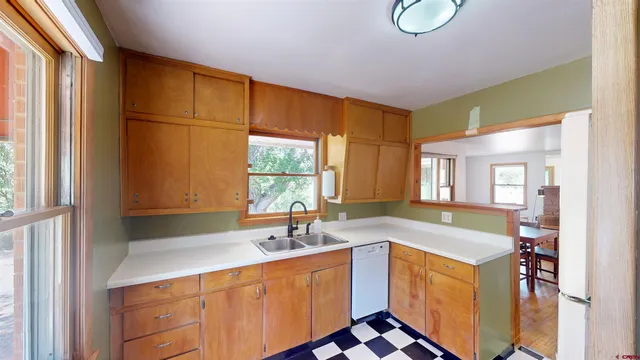 a spacious bathroom with a sink a mirror and a bathtub next to a window