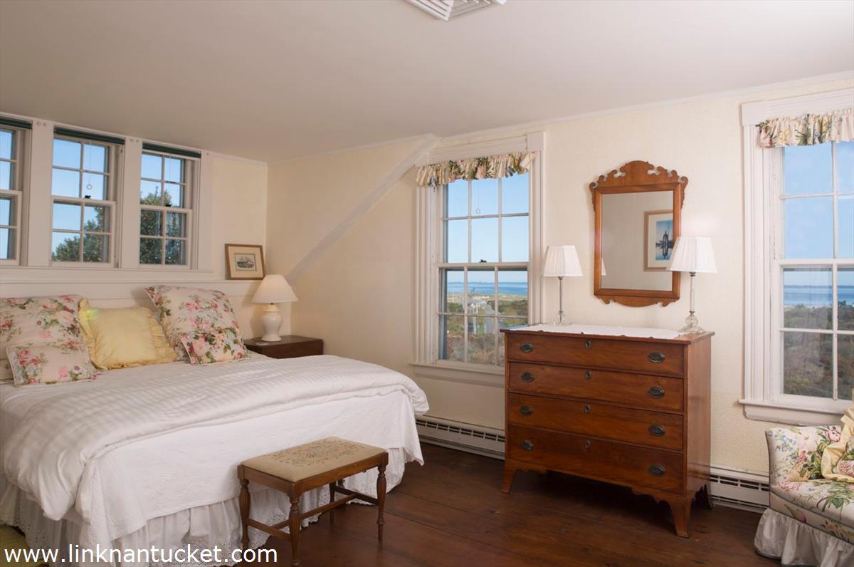47 Cliff Road Nantucket, MA 02554 - Photo 22 of 22 a bedroom with a bed and wooden floor