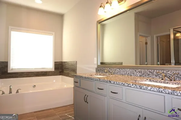 a bathroom with a bathtub and a sink