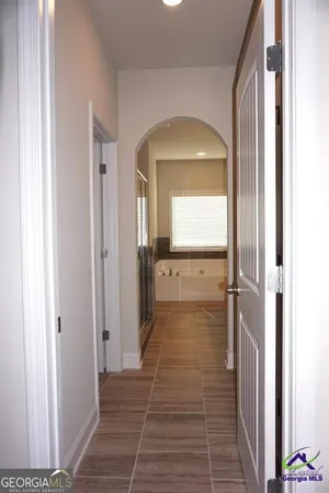 a view of a hallway with a wooden door