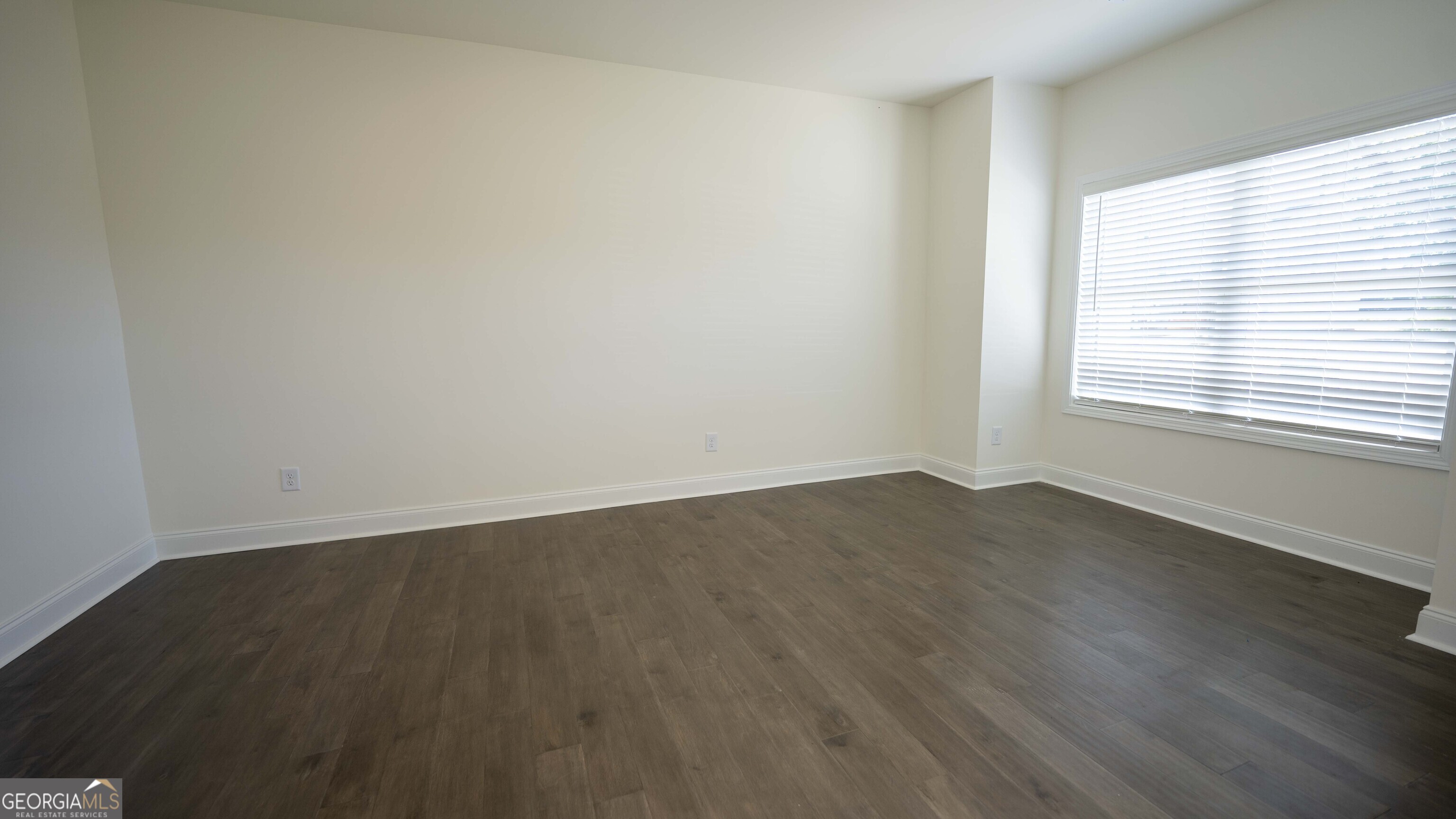 124 Bluecoat Trail Byron, GA 31008 - Photo 19 of 86 an empty room with wooden floor and windows